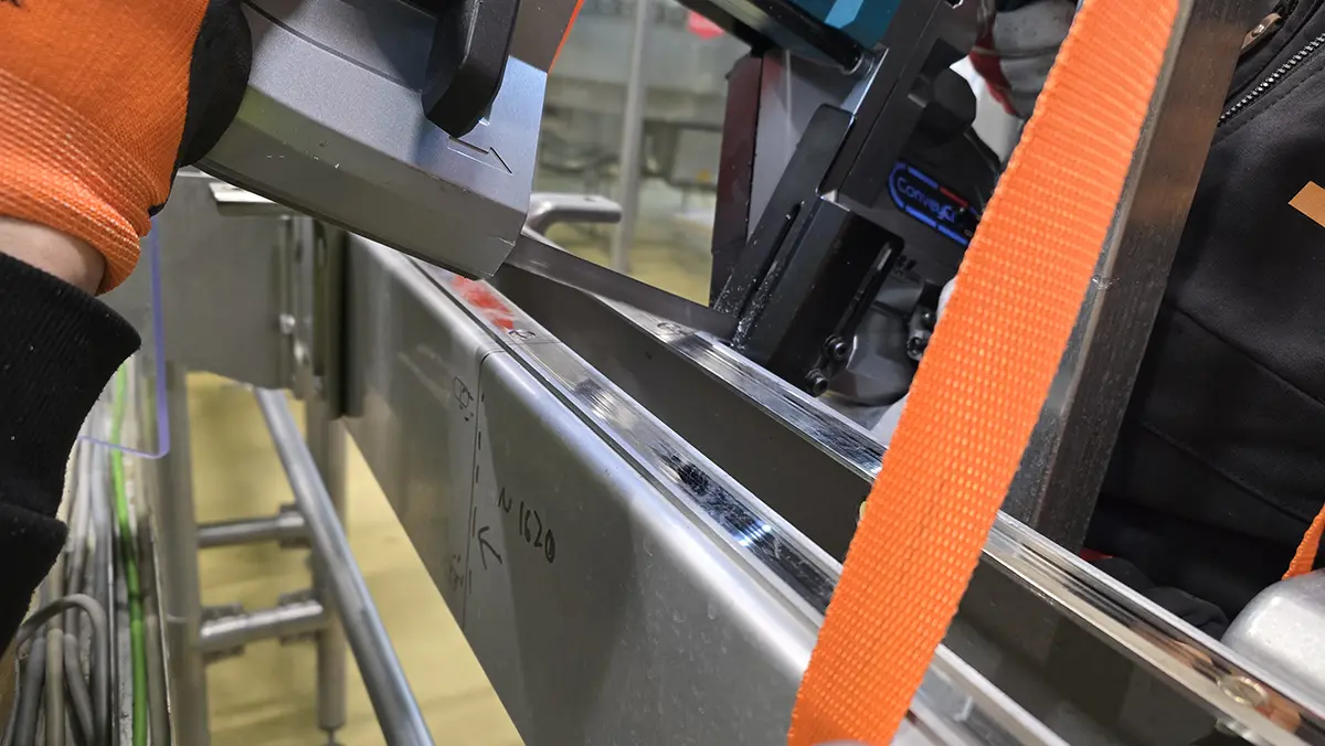 Technician inspecting a conveyor assembly
