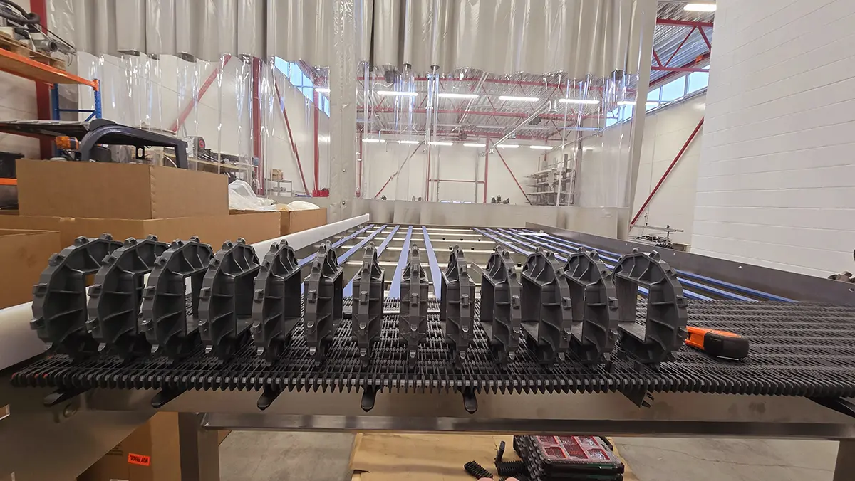 Technician inspecting a conveyor assembly